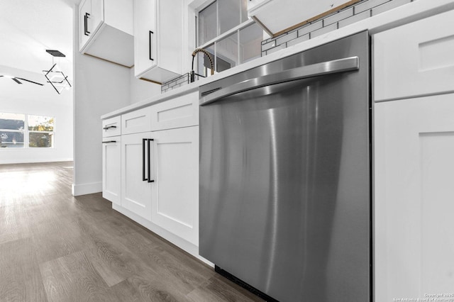 kitchen featuring white cabinetry, stainless steel dishwasher, and dark hardwood / wood-style floors