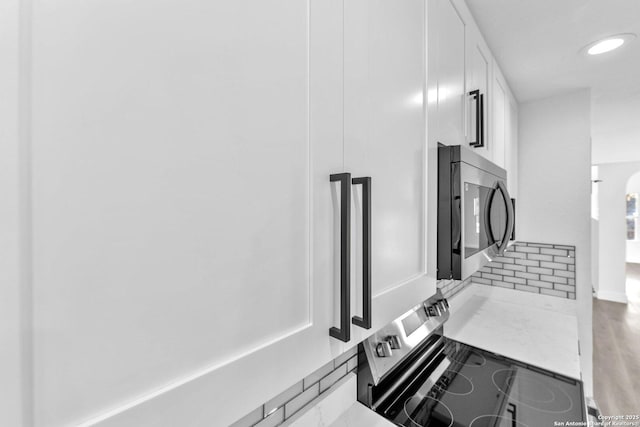 kitchen with white cabinets and electric range oven