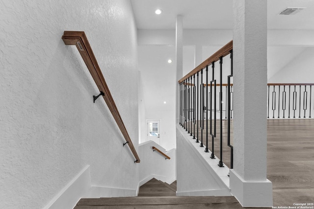 stairs with hardwood / wood-style flooring