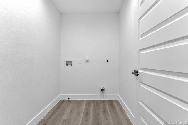 clothes washing area with hookup for an electric dryer, hookup for a gas dryer, hardwood / wood-style floors, and washer hookup