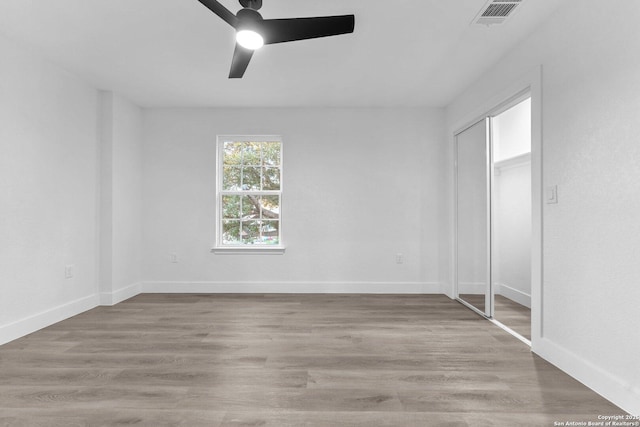 empty room with ceiling fan and light wood-type flooring