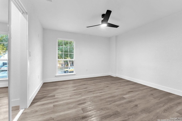 spare room featuring hardwood / wood-style flooring and ceiling fan