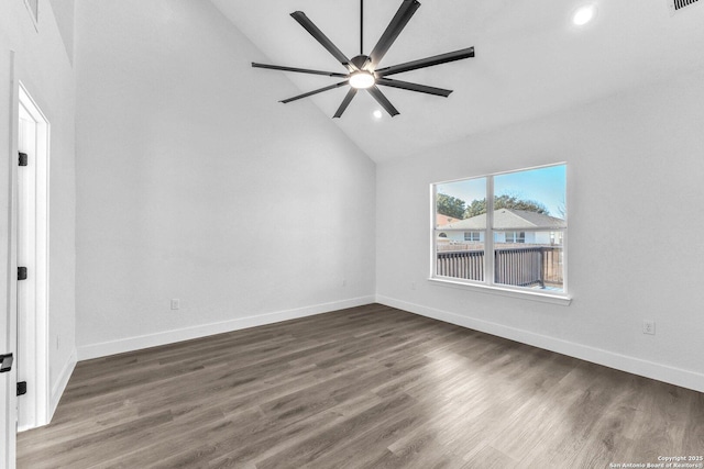 empty room featuring ceiling fan, dark wood-type flooring, and vaulted ceiling