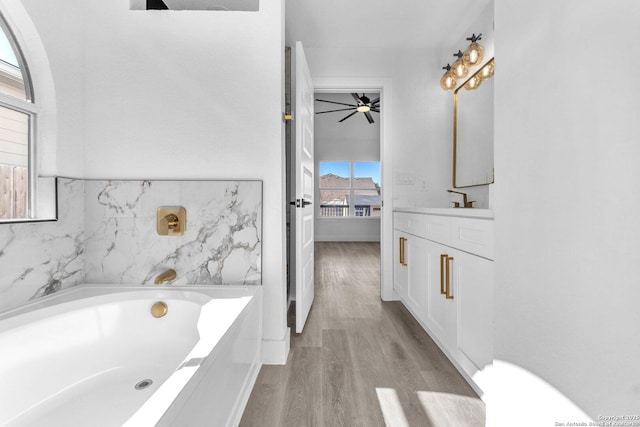 bathroom featuring vanity, hardwood / wood-style flooring, and a bathing tub