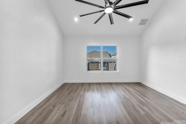 spare room with hardwood / wood-style floors and ceiling fan