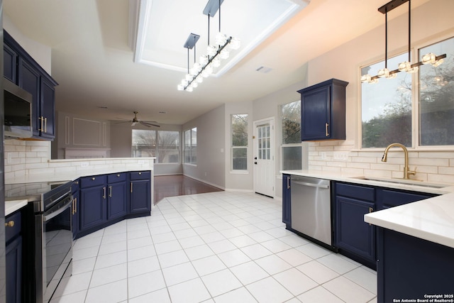 kitchen featuring pendant lighting, stainless steel appliances, tasteful backsplash, and sink