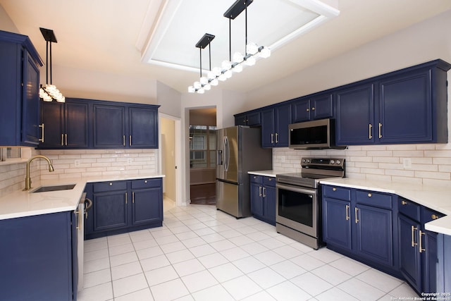 kitchen featuring blue cabinetry, appliances with stainless steel finishes, decorative light fixtures, and decorative backsplash