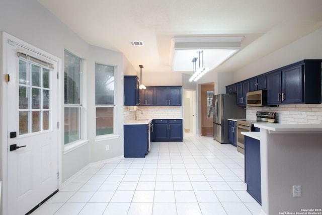 kitchen featuring backsplash, stainless steel appliances, blue cabinets, and sink