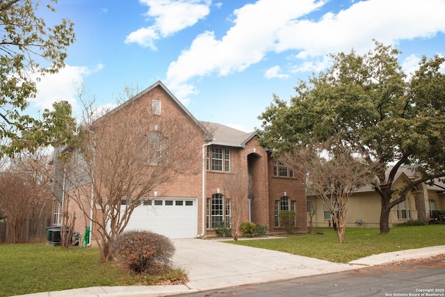 traditional home featuring a front yard, fence, an attached garage, concrete driveway, and brick siding