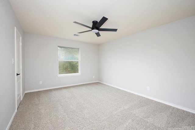 carpeted spare room with ceiling fan