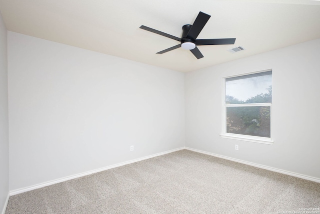 carpeted spare room featuring ceiling fan