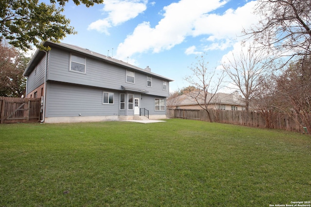 back of property featuring a patio area and a yard