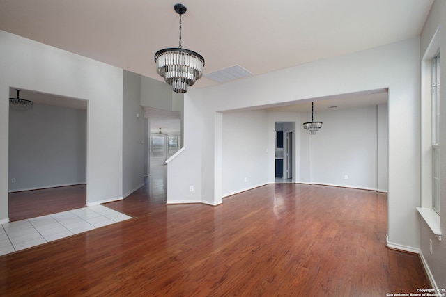 interior space featuring light wood-type flooring and an inviting chandelier