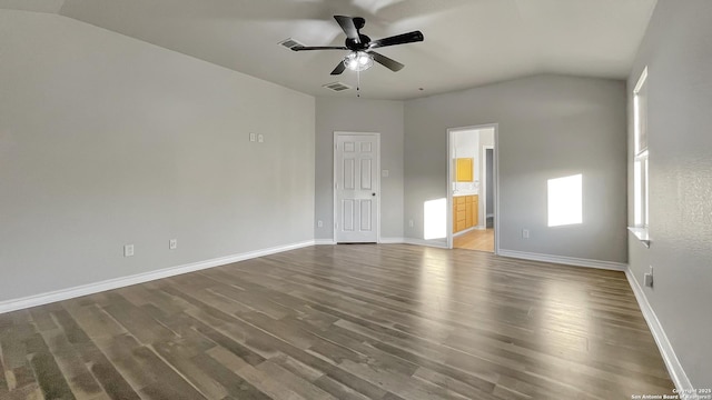 unfurnished room featuring ceiling fan, dark hardwood / wood-style flooring, and vaulted ceiling