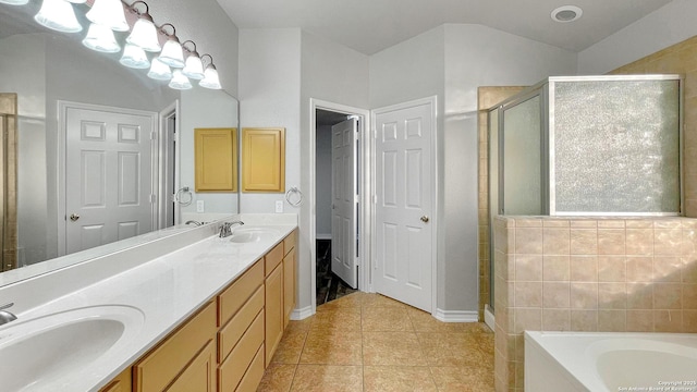 bathroom featuring tile patterned floors, vanity, and shower with separate bathtub