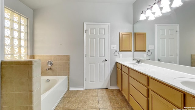 bathroom featuring tile patterned floors, a bathing tub, and vanity