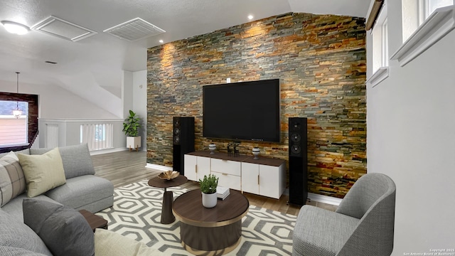 living room featuring light wood-type flooring and lofted ceiling