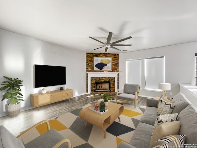 living room with ceiling fan, a fireplace, and light wood-type flooring