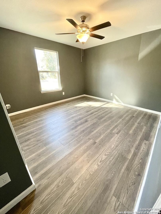 spare room featuring ceiling fan and wood-type flooring