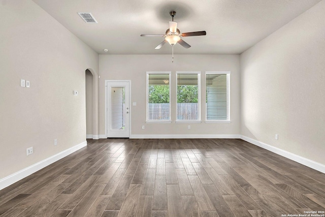 empty room with dark hardwood / wood-style floors and ceiling fan