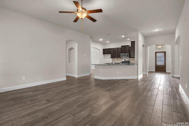 unfurnished living room with ceiling fan