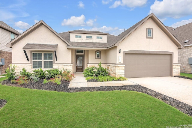 view of front facade with a garage and a front lawn