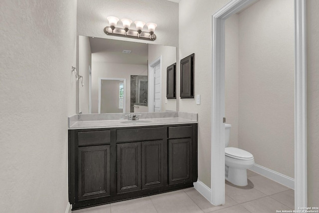 bathroom featuring tile patterned floors, vanity, and toilet