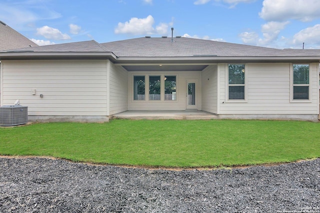 back of property featuring cooling unit, a yard, and a patio