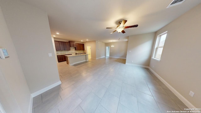 unfurnished living room featuring ceiling fan