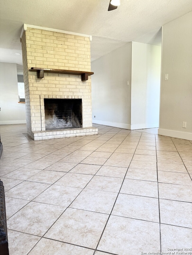 unfurnished living room with a fireplace, light tile patterned flooring, and a textured ceiling