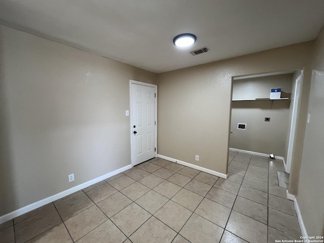 laundry room with hookup for an electric dryer, hookup for a washing machine, and light tile patterned floors