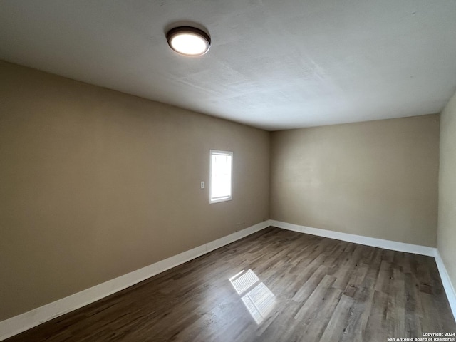 unfurnished room with wood-type flooring