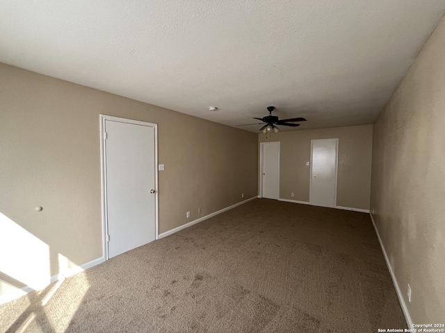 unfurnished room with carpet flooring and ceiling fan