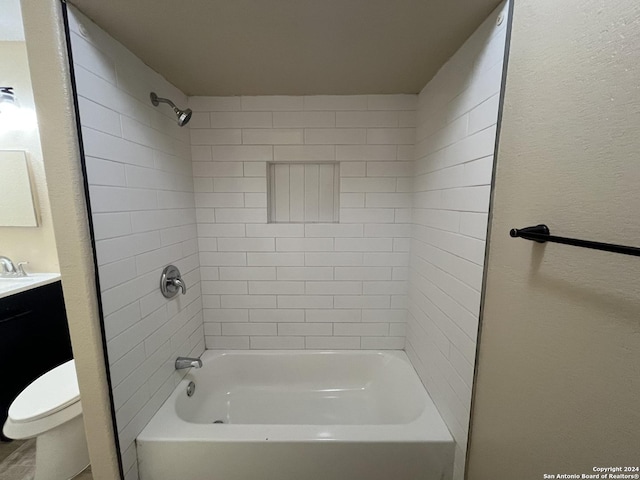 full bathroom with tiled shower / bath combo, toilet, and vanity