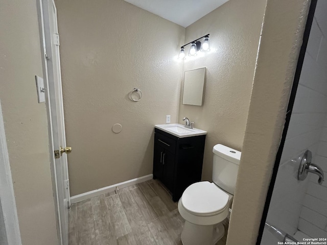 bathroom featuring hardwood / wood-style floors, vanity, and toilet