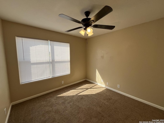 carpeted empty room with ceiling fan