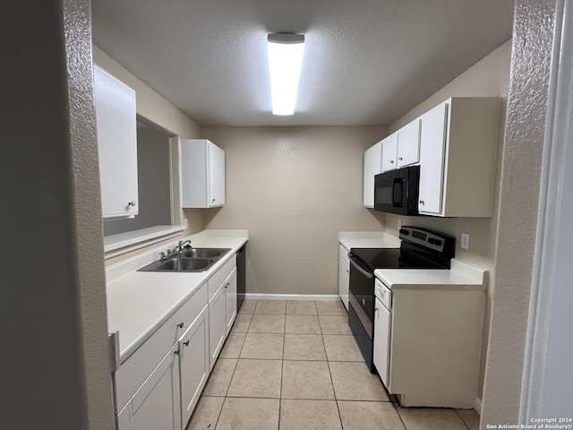 kitchen featuring a textured ceiling, sink, black appliances, light tile patterned floors, and white cabinets