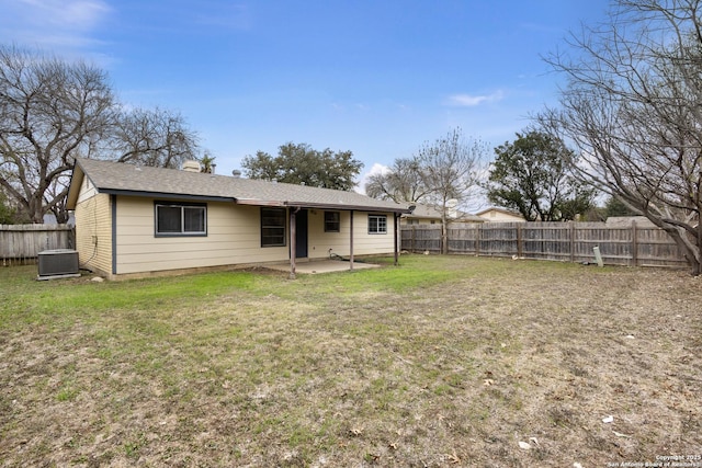 back of house with a lawn, cooling unit, and a patio