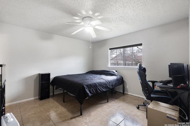 tiled bedroom featuring ceiling fan and a textured ceiling