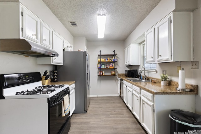 kitchen with white cabinetry, range with gas cooktop, light wood-type flooring, a textured ceiling, and sink