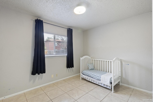 tiled bedroom featuring a textured ceiling