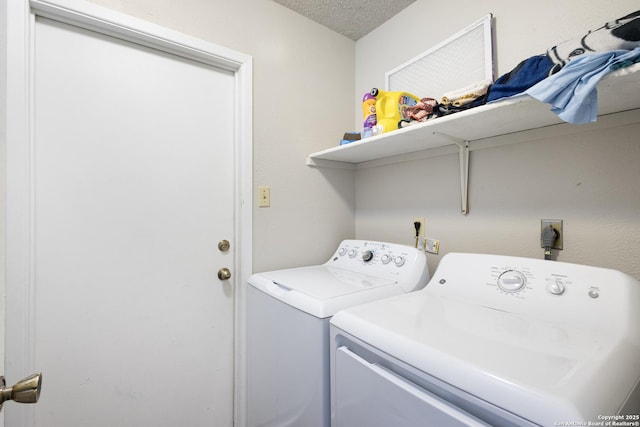 laundry room featuring independent washer and dryer and a textured ceiling