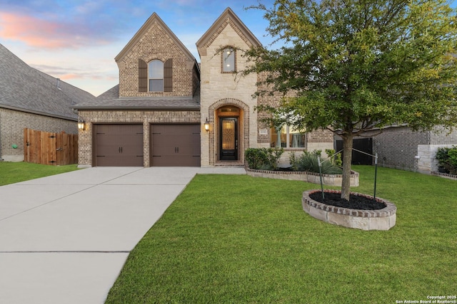 french country home with a garage and a yard