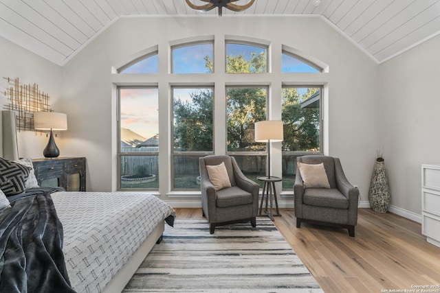 bedroom featuring light hardwood / wood-style flooring, wood ceiling, and vaulted ceiling