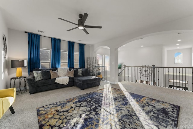 living room featuring carpet flooring and ceiling fan