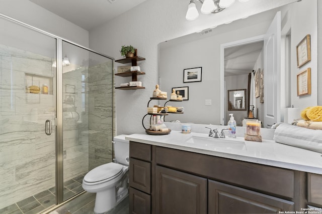 bathroom with vanity, toilet, and walk in shower