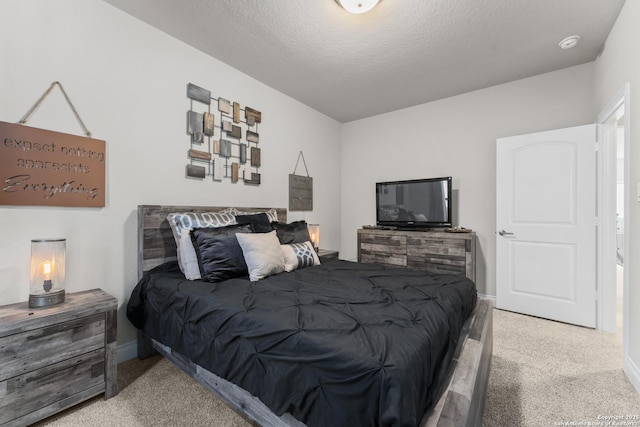 carpeted bedroom featuring a textured ceiling