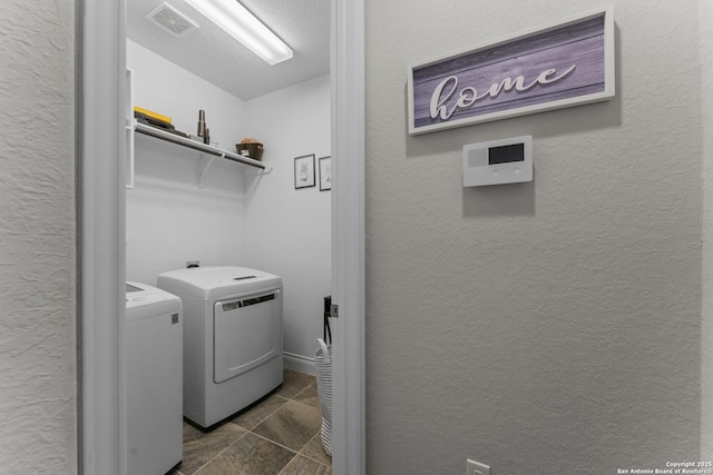 clothes washing area with washer and clothes dryer