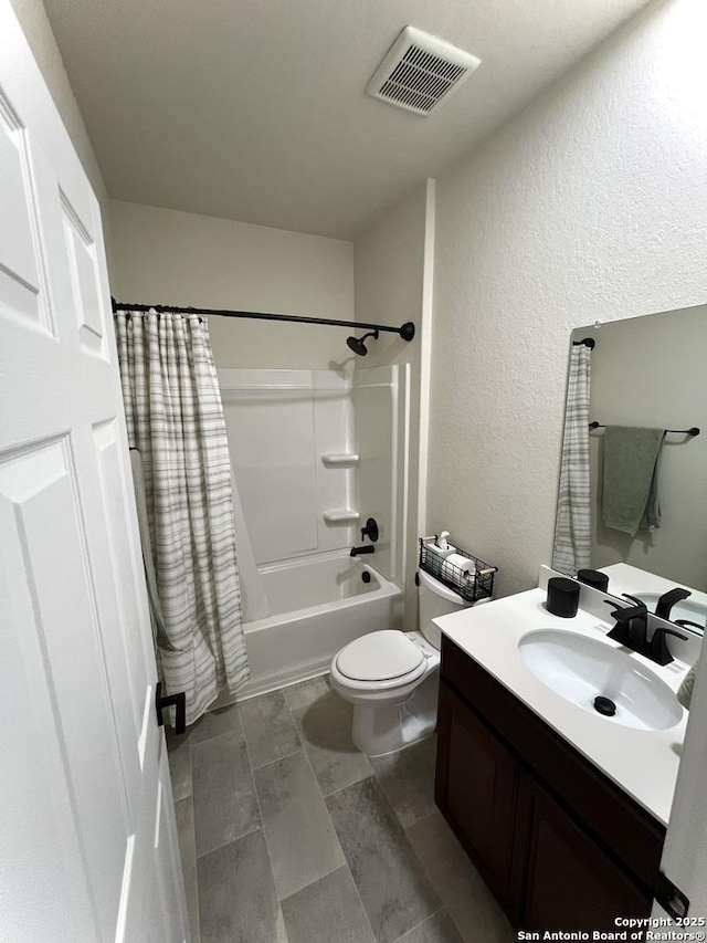 full bathroom featuring vanity, shower / tub combo, and toilet