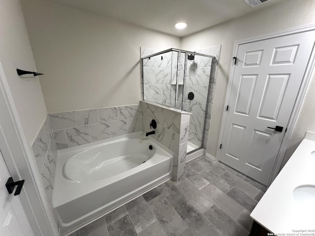 bathroom with vanity and independent shower and bath